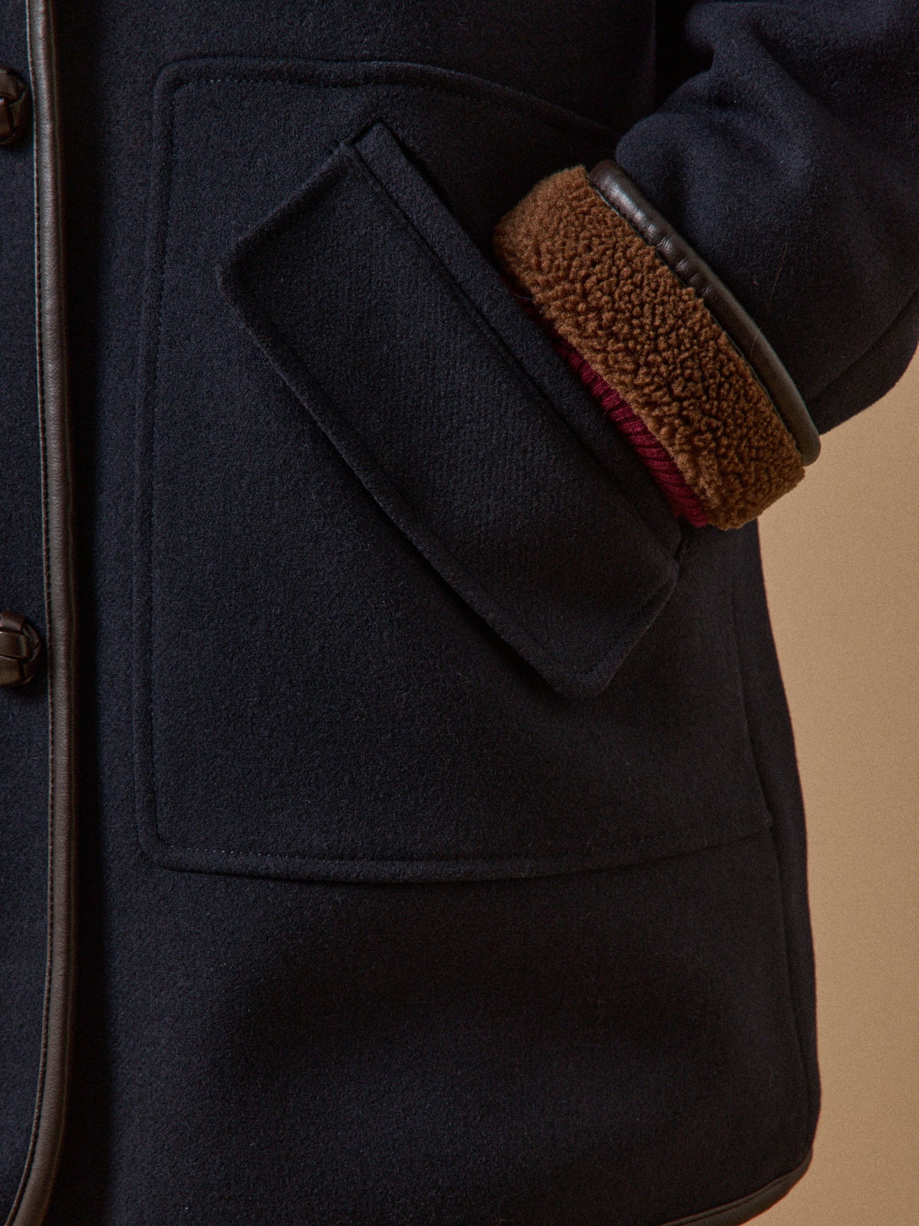 Women's coat with trimmed sherpa lining