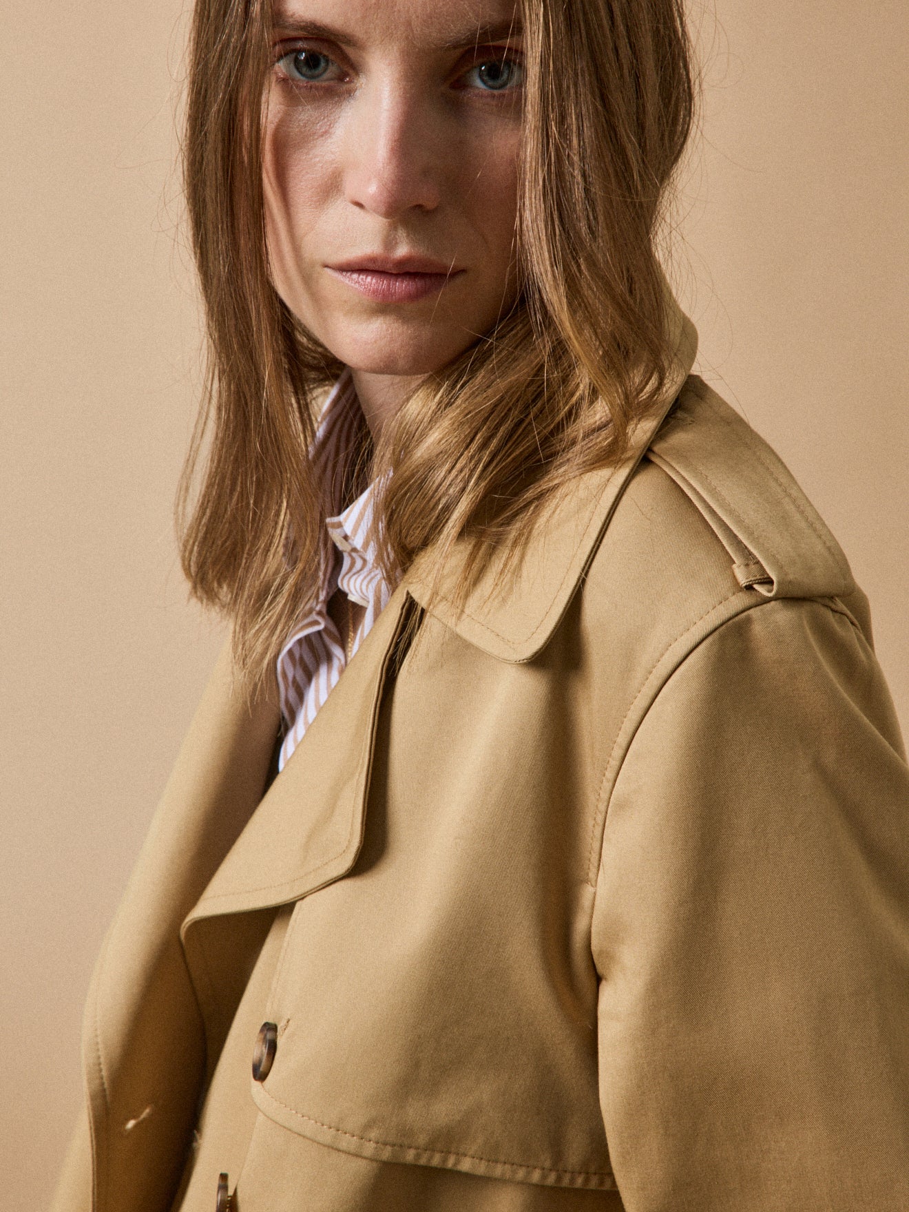 Women's long organic cotton trench coat with notched lapels