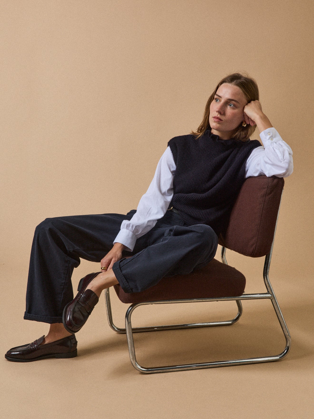 Women's sleeveless sweater with ruffled neckline