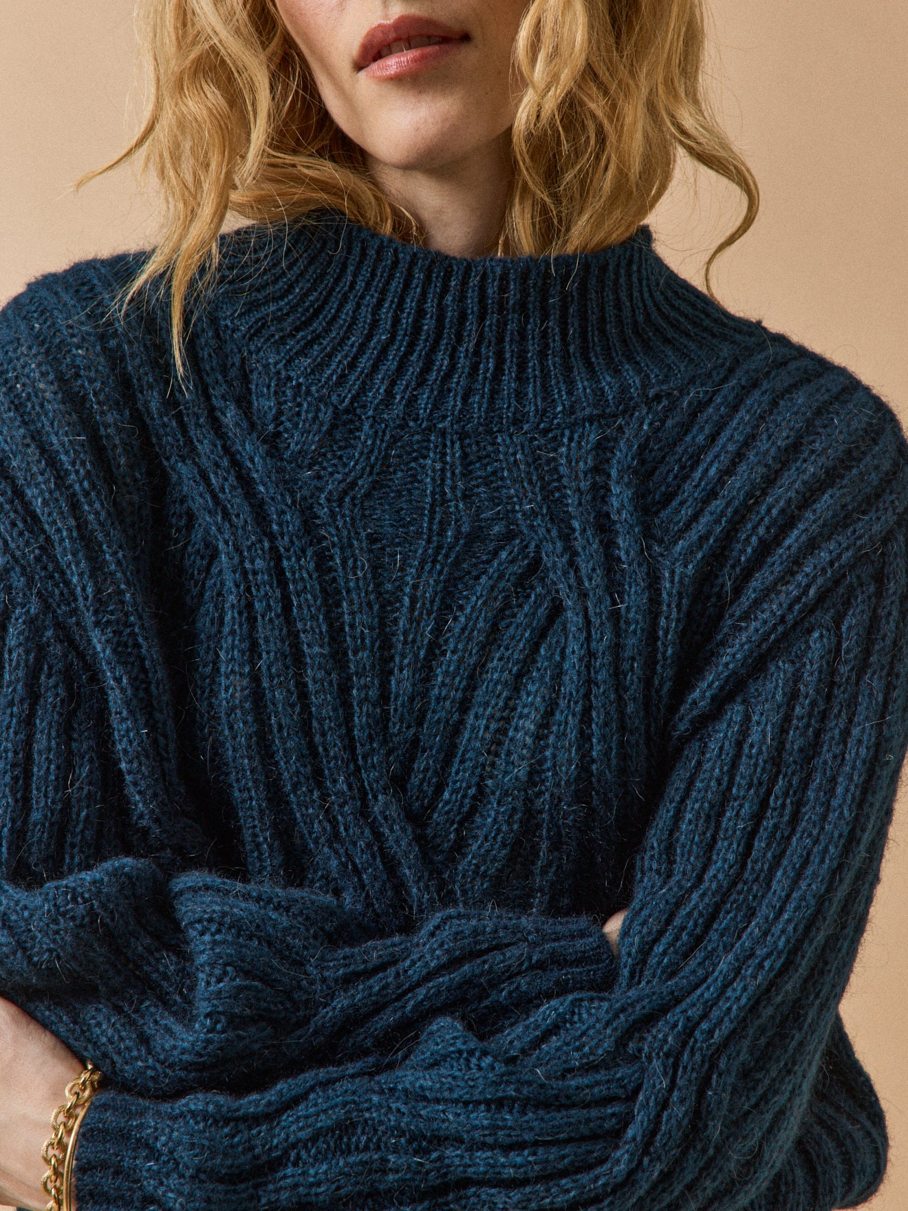 Women's cable knit sweater with high neckline