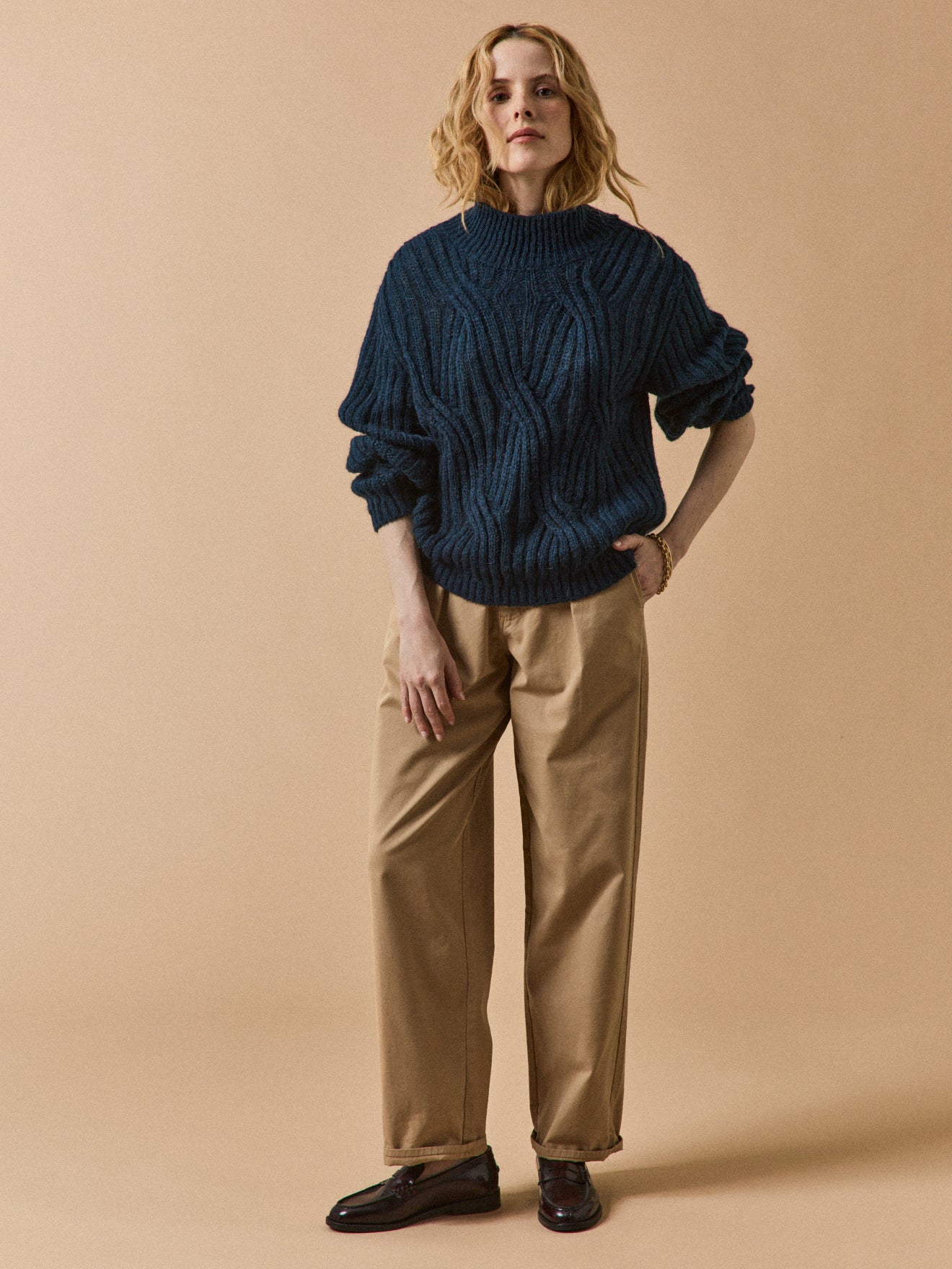 Women's cable knit sweater with high neckline