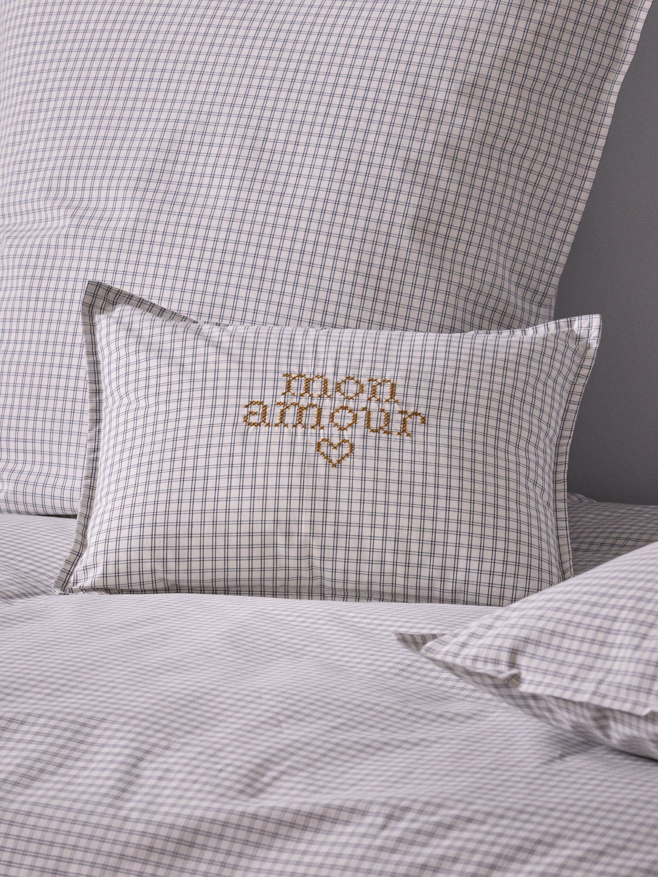 Cushion cover with small embroidered checks