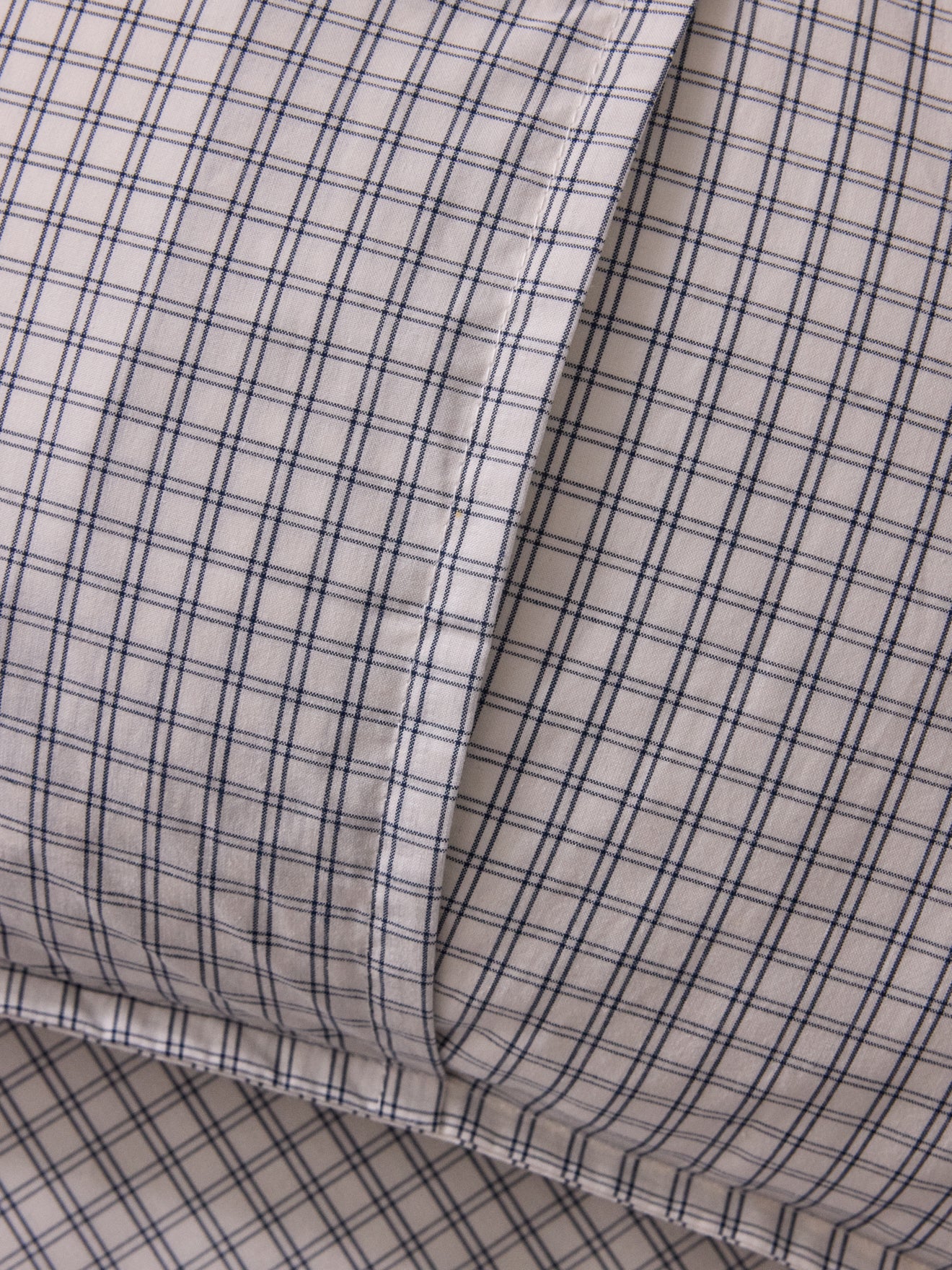 Cushion cover with small embroidered checks